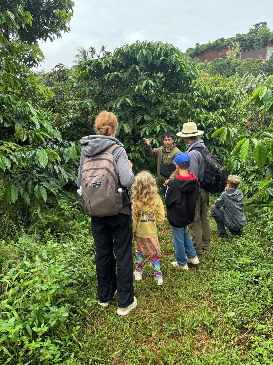 Group standing at Robusta coffee farm in Da Lat, Vietnam — sustainable cultivation with biodiversity and no pesticides.
